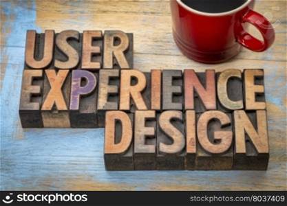 user experience design - word abstract in vintage letterpress wood type with a cup of coffee