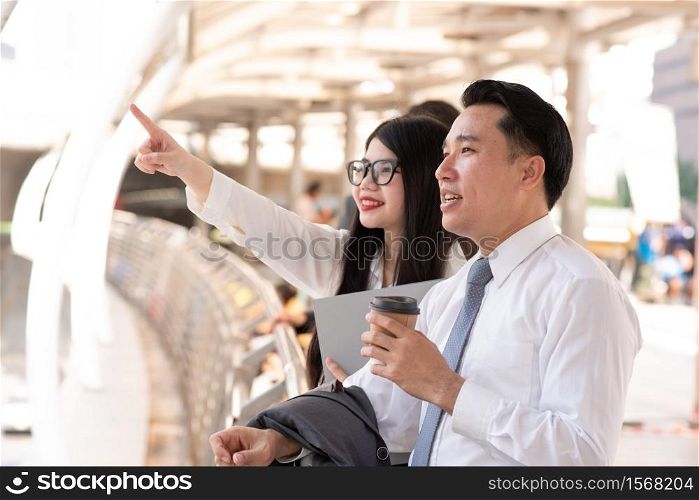 usinesswoman Pointing By Businessman While Standing On Bridge