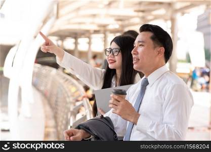 usinesswoman Pointing By Businessman While Standing On Bridge