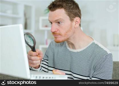using a magnifying glass to read something in the internet