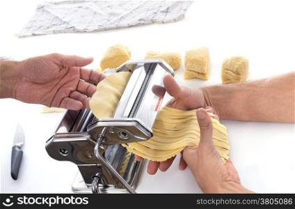 Using a pasta maker in front of white background