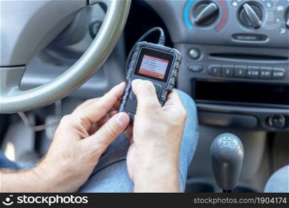 Using diagnostic car code reader to erase error codes and turn off check engine light