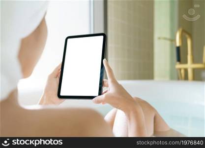 Using digital tablet, Women holding digital tablet while soaking in the bathtub in moring