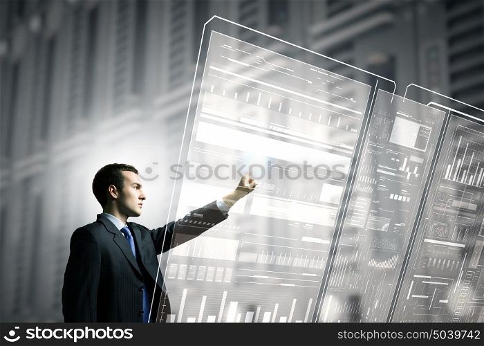 Using innovative technologies. Businessman pushing with finger icon on virtual screen