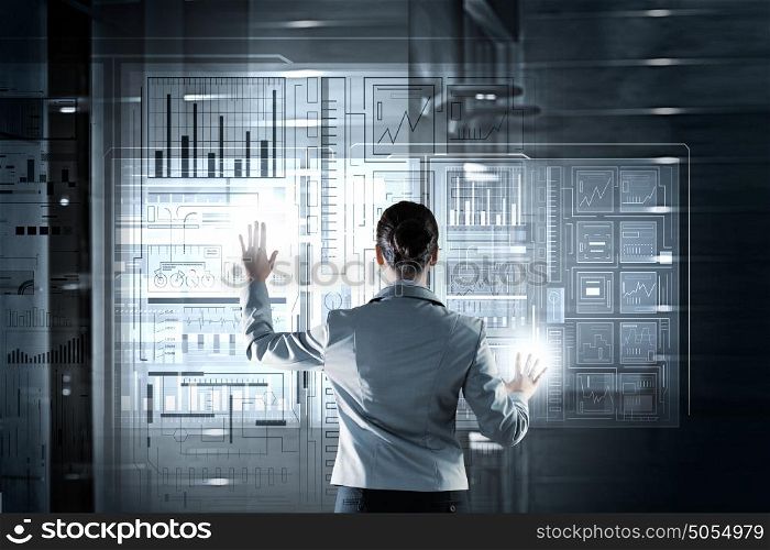 Using innovative technologies. Businesswoman pushing with finger icon on virtual screen