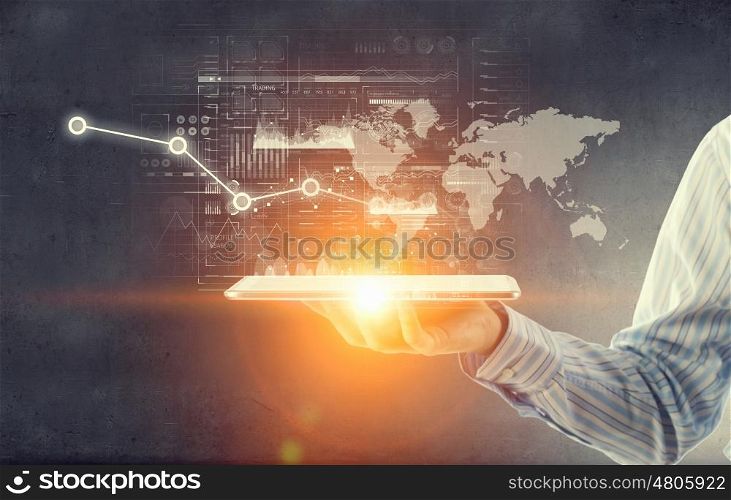 Using innovative technologies. Hand of businessman presenting tablet as concept of global connection device