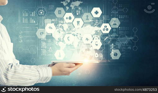 Using innovative technologies. Hand of businessman presenting tablet as concept of global connection device