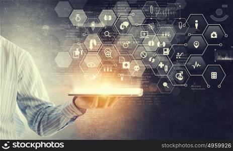 Using innovative technologies. Hand of businessman presenting tablet as concept of global connection device