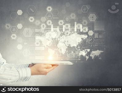 Using innovative technologies. Hand of businessman presenting tablet as concept of global connection device