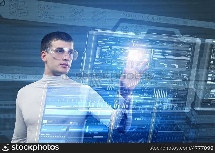 Using innovative technologies. Young man pushing with finger icon on virtual screen