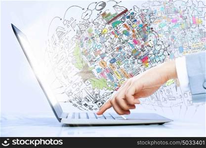 Using laptop. Close up image of laptop and human hands typing on keyboard