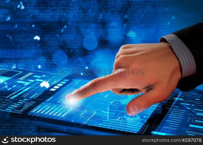 Using modern technologies. Close up of finger touching blue toned screen on tablet pc