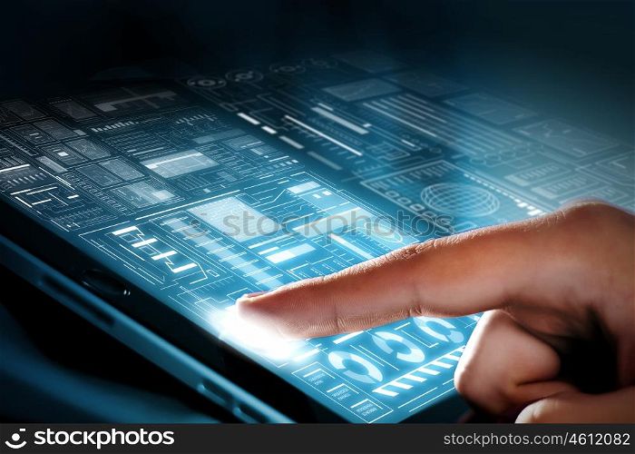 Using modern technologies. Close up of finger touching blue toned screen on tablet pc