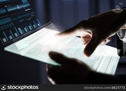 Using modern technologies. Close up of human hands using virtual panel