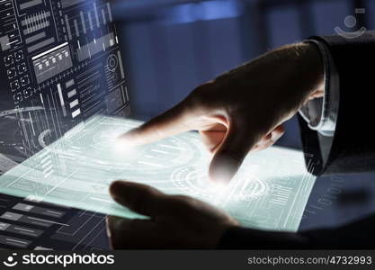 Using modern technologies. Close up of human hands using virtual panel