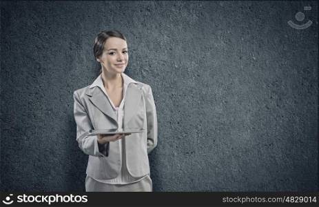 Using tablet pc. Young businesswoman holding tablet pc in hands