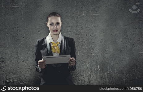 Using tablet pc. Young businesswoman holding tablet pc in hands