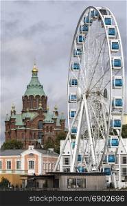 Uspenski Cathedral and the Skywheel in the city of Helsinki in Finland.