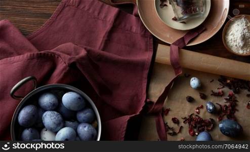 Utensils for preparing and colored eggs on rustic table, flat lay. Preparation for Easter