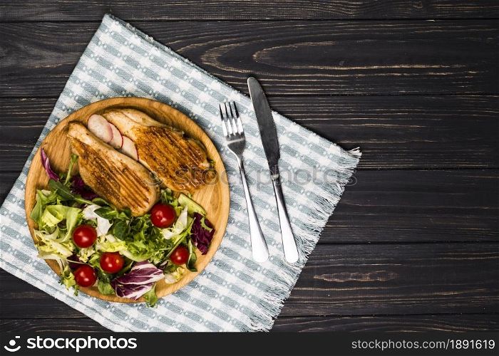 utensils near roasted chicken and salad. Resolution and high quality beautiful photo. utensils near roasted chicken and salad. High quality and resolution beautiful photo concept