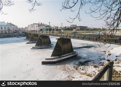 Uzhgorod pedestrian bridge in the center of city with ice and snow