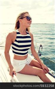 vacation, holidays, travel, sea and people concept - smiling young woman sitting on yacht deck