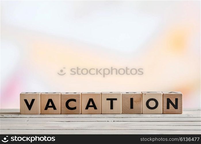 Vacation message made of wooden cubes on a table