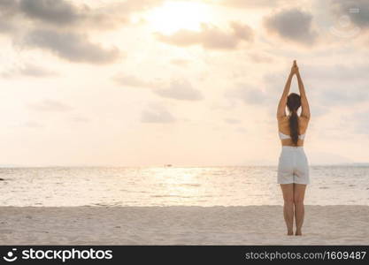 Vacation of Beautiful Attractive Asian woman relaxing in yoga lotus pose on the pool above the beach with beautiful sea in Tropical island,Feeling comfortable and relax in holiday,Vacations Concept