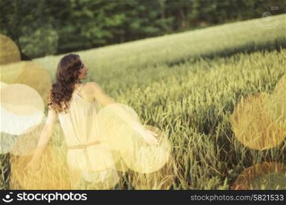 Vacation picture of the young woman among the corn crop
