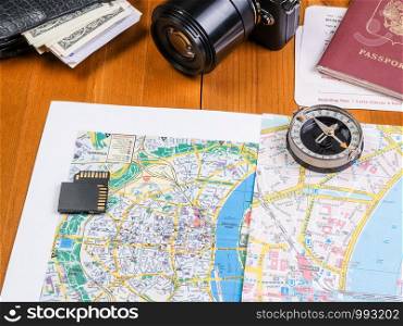 Vacation planning. A table with passport cards and a camera. map, camera and compass and travel accessories