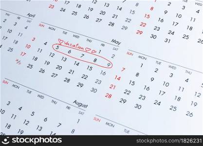 Vacation planning concept. Travel preparation: Vacation plans written on the calendar