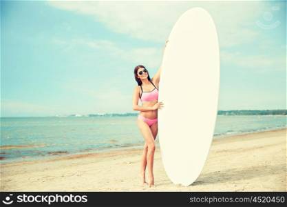 vacation, surfing, water sport and people concept - young woman in swimsuit with surfboard, windsurf or paddle board on summer beach
