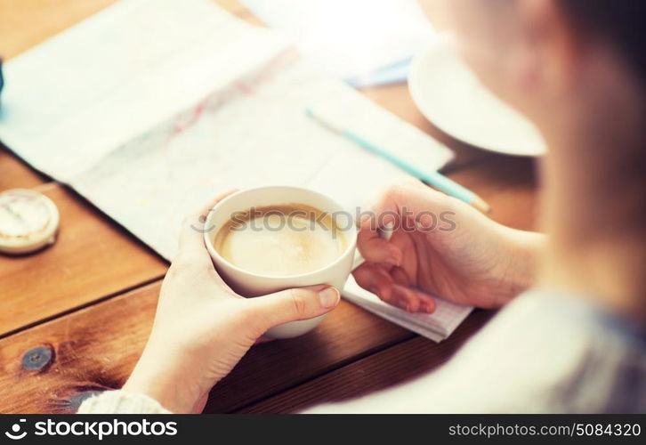 vacation, tourism, travel, destination and people concept - close up of hands with coffee cup and travel stuff. close up of hands with coffee cup and travel stuff. close up of hands with coffee cup and travel stuff