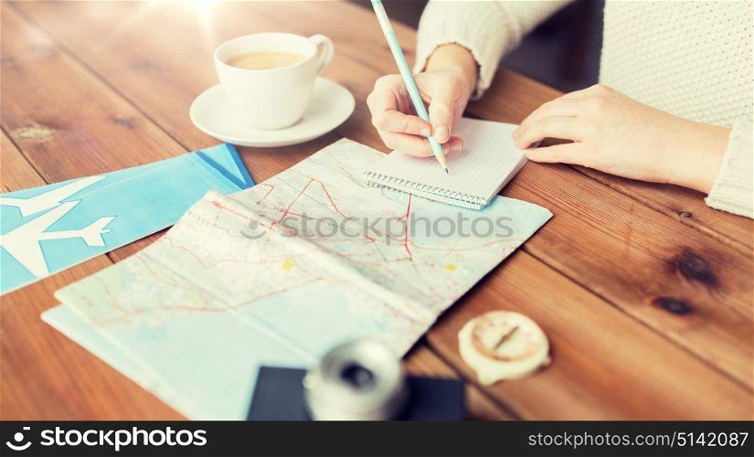 vacation, tourism, travel, destination and people concept - close up of traveler hands with blank notepad and pencil. close up of traveler hands with notepad and pencil