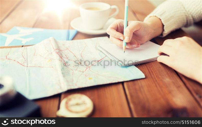 vacation, tourism, travel, destination and people concept - close up of traveler hands with blank notepad and pencil. close up of traveler hands with notepad and pencil