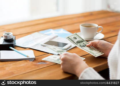 vacation, tourism, travel, finances and people concept - close up of traveler hands counting dollar cash money