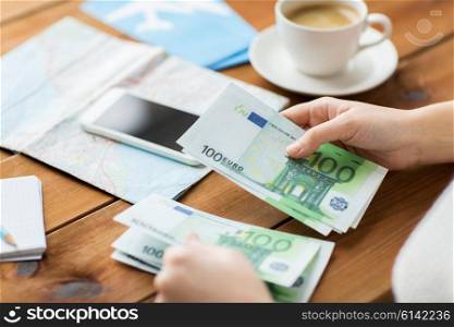 vacation, tourism, travel, finances and people concept - close up of traveler hands counting euro cash money