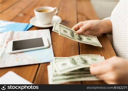 vacation, tourism, travel, finances and people concept - close up of traveler hands counting dollar cash money