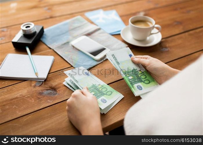 vacation, tourism, travel, finances and people concept - close up of traveler hands counting euro cash money