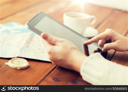 vacation, tourism, travel, technology and people concept - close up of traveler hands with blank tablet pc computer and map. close up of traveler hands with tablet pc and map. close up of traveler hands with tablet pc and map