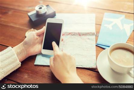vacation, tourism, travel, technology and people concept - close up of traveler hands with blank smartphone screen and map. close up of traveler hands with smartphone and map. close up of traveler hands with smartphone and map