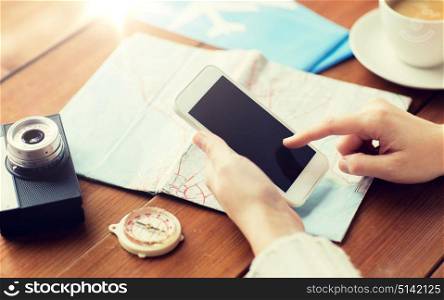 vacation, tourism, travel, technology and people concept - close up of traveler hands with blank smartphone screen and map. close up of traveler hands with smartphone and map