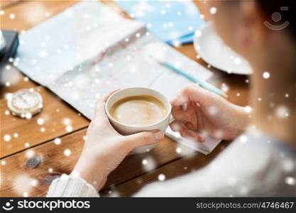 vacation, tourism, winter holidays and people concept - close up of hands with coffee cup and travel stuff