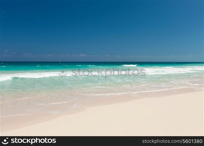 vacation, travel and background concept - blue sea or ocean, white sand and sky