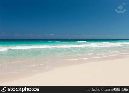 vacation, travel and background concept - blue sea or ocean, white sand and sky