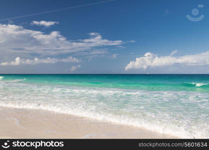 vacation, travel and background concept - blue sea or ocean, white sand and sky with clouds