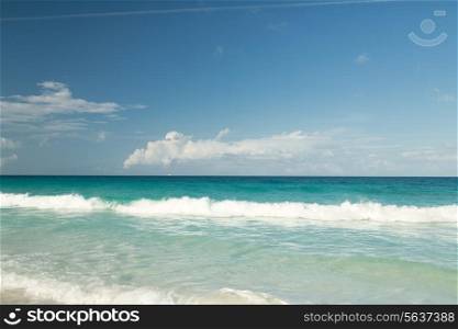 vacation, travel and background concept - blue sea or ocean, white sand and sky with clouds