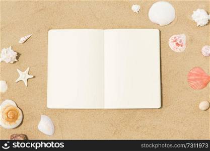 vacation, travel and summer concept - notebook with seashells on beach sand. notebook with seashells on beach sand