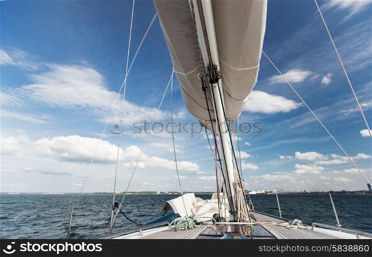 vacation, travel, cruise and leisure concept - close up of sailboat mast or yacht sailing on sea