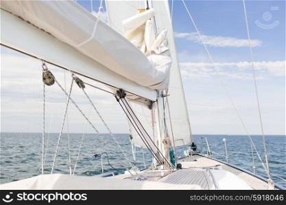 vacation, travel, cruise and leisure concept - close up of sailboat mast or yacht sailing on sea